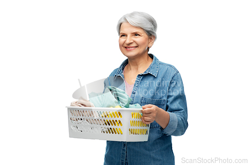 Image of smiling senior woman with laundry basket