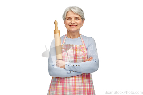 Image of smiling senior woman in apron with rolling pin