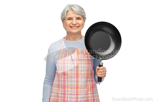 Image of smiling senior woman in apron with frying pan