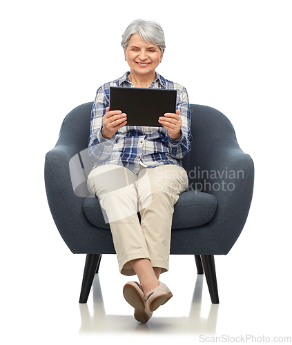 Image of happy senior woman with tablet pc sitting in chair