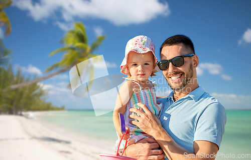 Image of happy father with little daughter on beach
