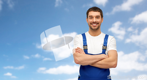 Image of happy smiling male worker or builder in overall