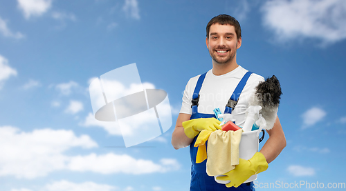 Image of male cleaner in overall with cleaning supplies