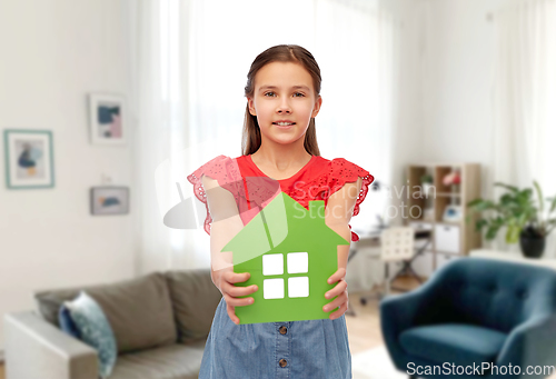Image of smiling little girl holding green house icon