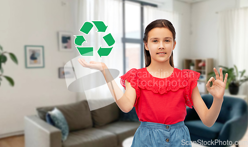 Image of smiling girl with green recycling sign showing ok
