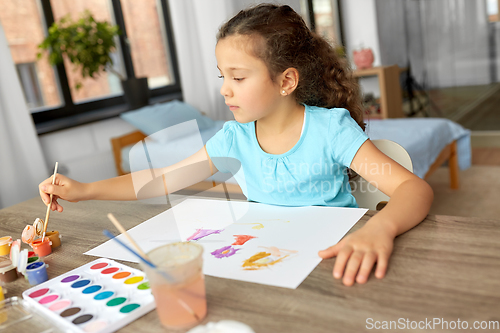 Image of little girl with colors drawing picture at home