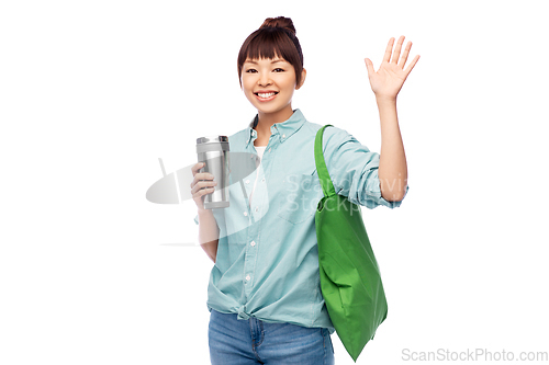 Image of woman with tumbler and reusable food shopping bag