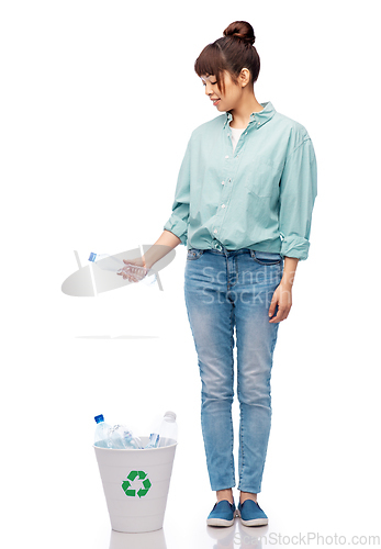 Image of smiling young woman sorting plastic waste