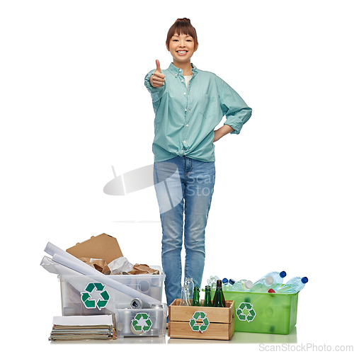 Image of happy woman sorting paper, metal and plastic waste