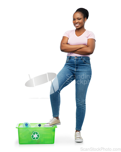 Image of smiling young asian woman sorting plastic waste