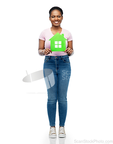 Image of smiling african american woman holding green house