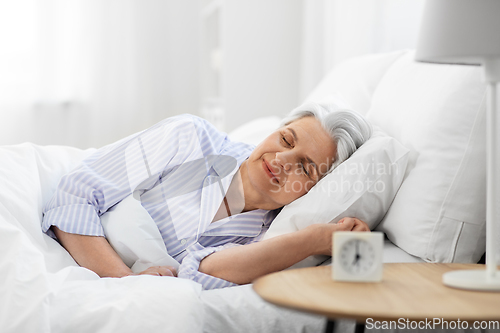 Image of senior woman sleeping in bed at home bedroom