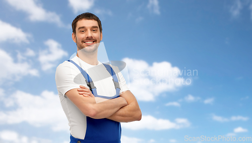 Image of happy smiling male worker or builder in overall