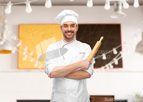 Image of happy smiling male chef or baker with rolling pin