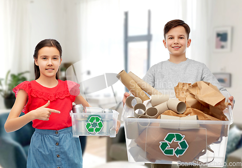 Image of smiling girl and boy sorting paper and metal waste