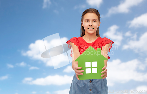 Image of smiling little girl holding green house icon