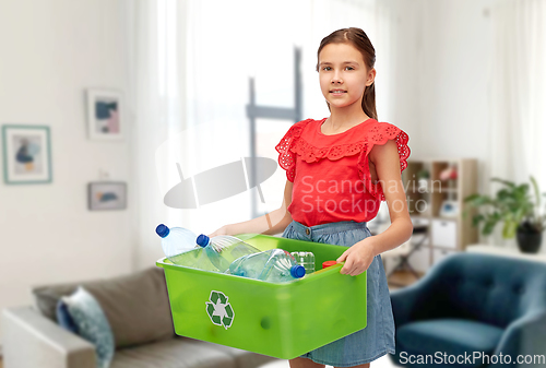 Image of smiling girl sorting plastic waste at home