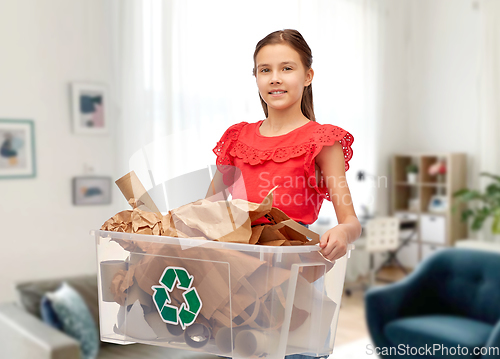 Image of smiling girl sorting paper waste at home