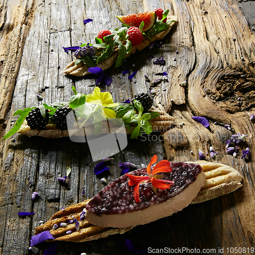 Image of Three portions of homemade dessert fresh berries on a wooden background