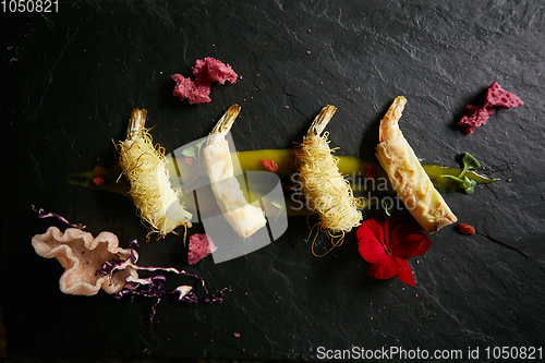 Image of Shrimp fried in rice noodles. Snack from shrimps. High kitchen. Film effect.