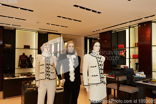 Image of Three womans mannequins in luxury clothes shop.