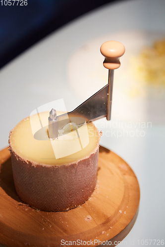Image of Swiss cheese Tete de Moine with a Girolle.