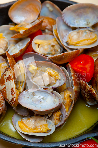 Image of fresh clams on an iron skillet