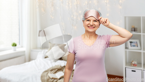 Image of senior woman in pajamas and eye sleeping mask