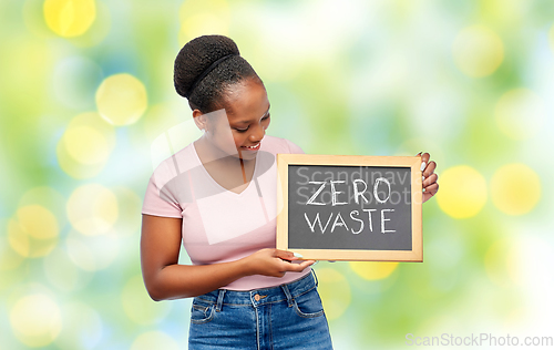 Image of happy woman holds chalkboard with zero waste words