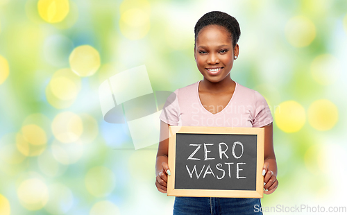 Image of happy woman holds chalkboard with zero waste words