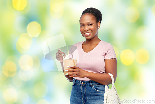 Image of happy woman with reusable bag for food and wok