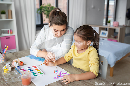 Image of mother with little daughter drawing at home