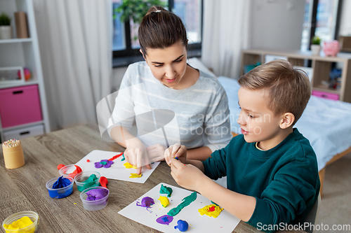 Image of mother and son playing with modeling clay at home