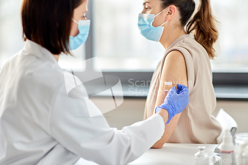 Image of close up of doctor attaching patch to patient