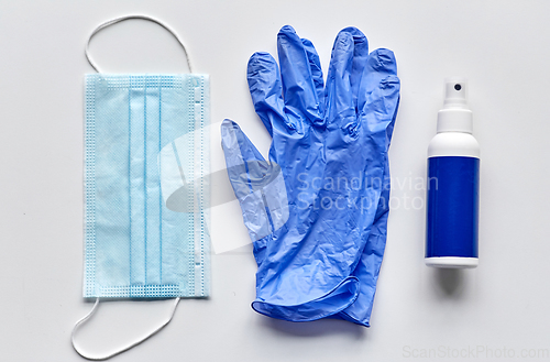Image of medical mask, gloves and hand sanitizer in spray
