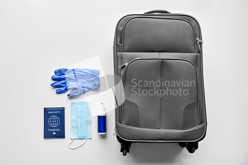 Image of immunity passport, mask, gloves, sanitizer and bag