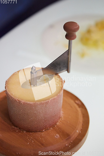 Image of Swiss cheese Tete de Moine with a Girolle.