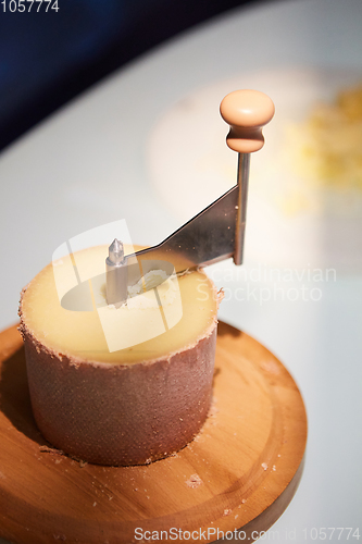 Image of Swiss cheese Tete de Moine with a Girolle.