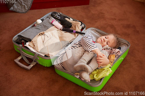 Image of Cute little child inside a big suitcase.