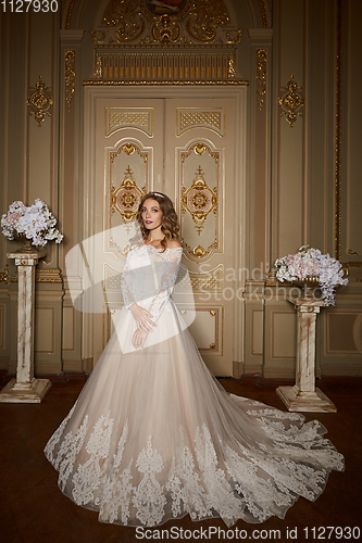 Image of Beautiful bride in luxury baroque interior. Full-length portrait.