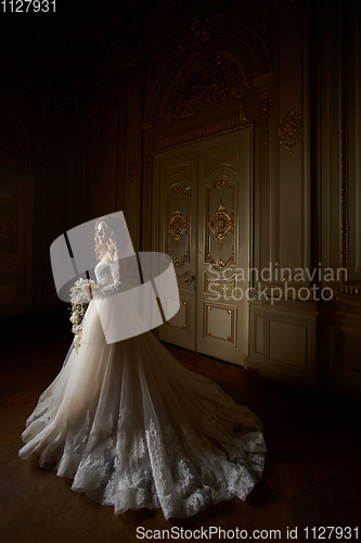 Image of Beautiful bride in luxury baroque interior. Full-length portrait.