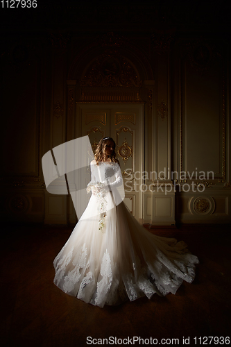 Image of Beautiful bride in luxury baroque interior. Full-length portrait.