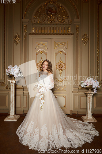 Image of Beautiful bride in luxury baroque interior. Full-length portrait.