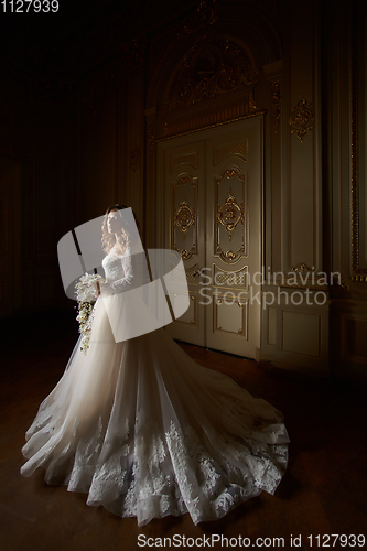 Image of Beautiful bride in luxury baroque interior. Full-length portrait.