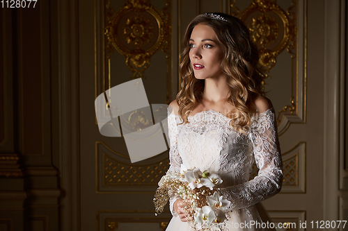 Image of Beautiful bride with bouquet in luxury interior in the Baroque style.