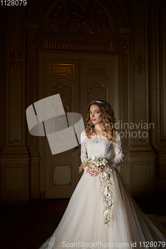 Image of Beautiful bride with bouquet in luxury interior in the Baroque style.