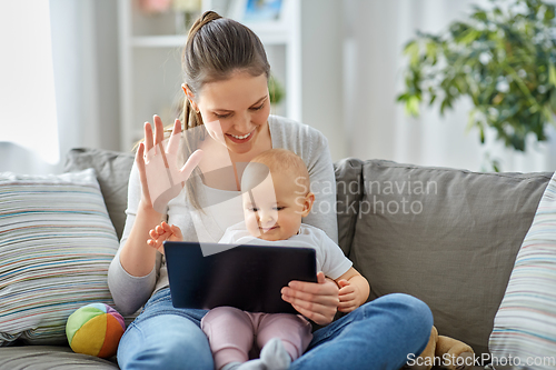 Image of mother with baby having video call on tablet pc