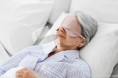 Image of senior woman with eye mask sleeping in bed at home