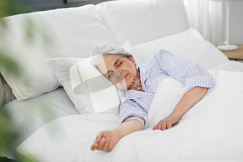 Image of senior woman sleeping in bed at home bedroom