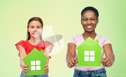 Image of african woman and caucasian girl with green houses